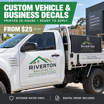 White ute with a Riverton Building Co. logo decal on the door and matching decal on the tray toolbox, parked at a construction site, promoting custom vehicle and business decals from $25 inc GST with outdoor-rated vinyl and digital proof included